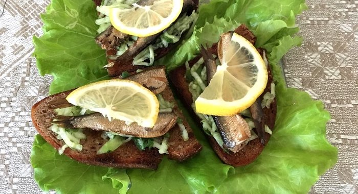 Закусочные бутерброды со шпротами зеленью и лимоном