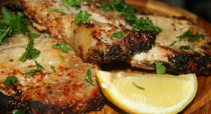 Свиная котлета на косточке с паприкой и кунжутом на липовой дощечке на мангале